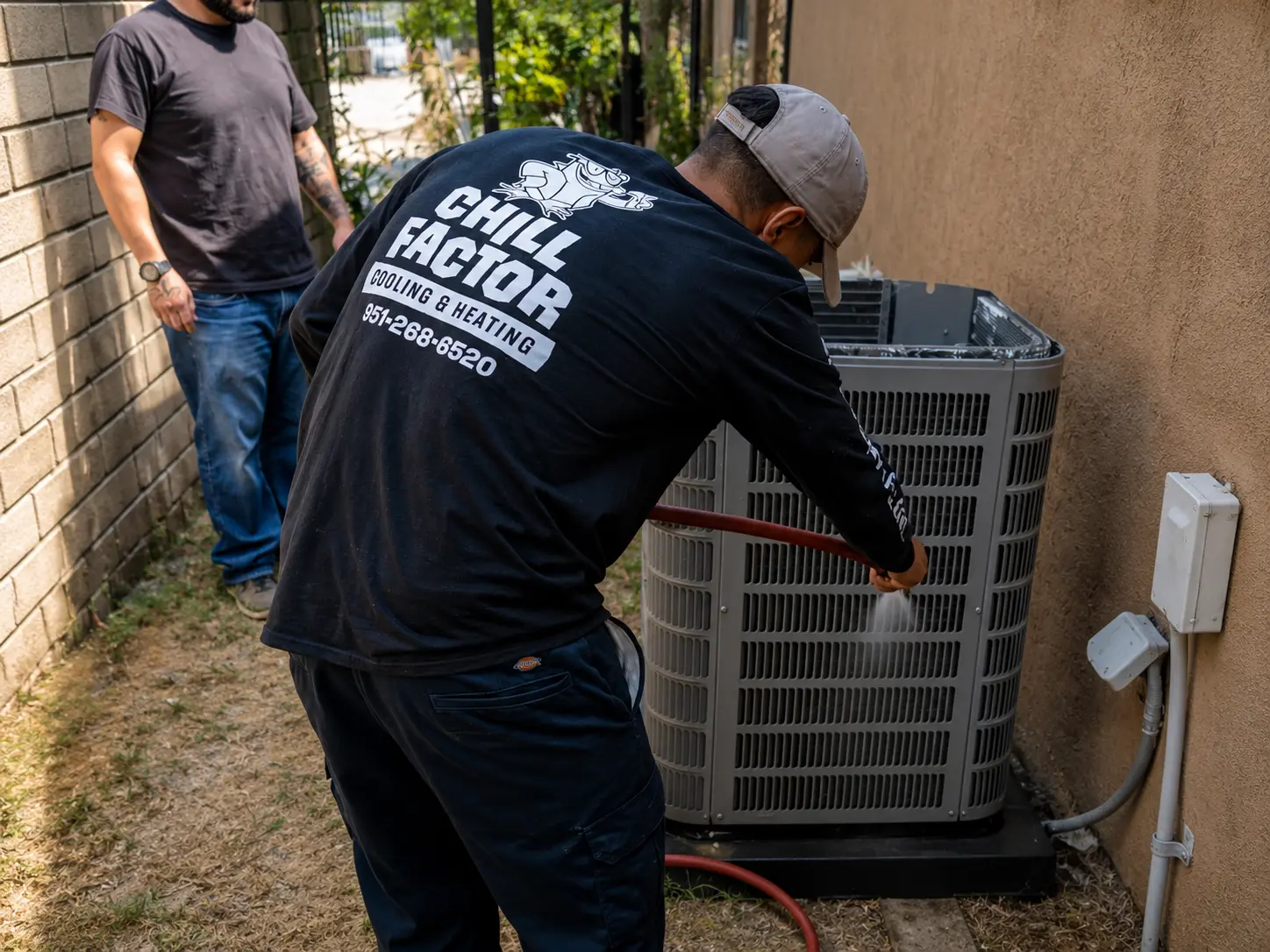 Professional AC maintenance technician in Inland Empire CA inspecting and servicing a residential air conditioning unit to improve cooling performance.