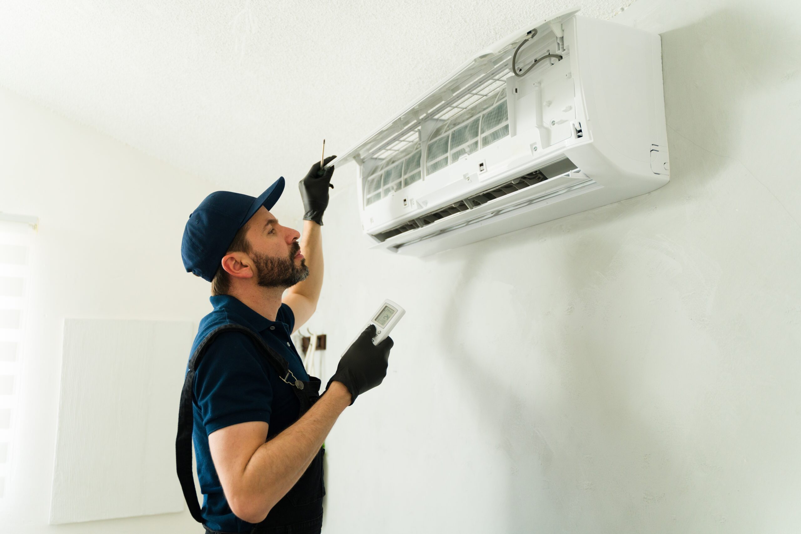 homeowner checking thermostat when AC stops working in a house