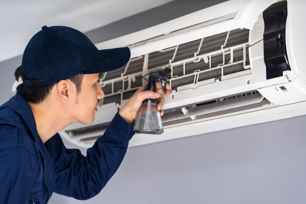 Technician inspecting an AC blowing warm air during a home cooling system check